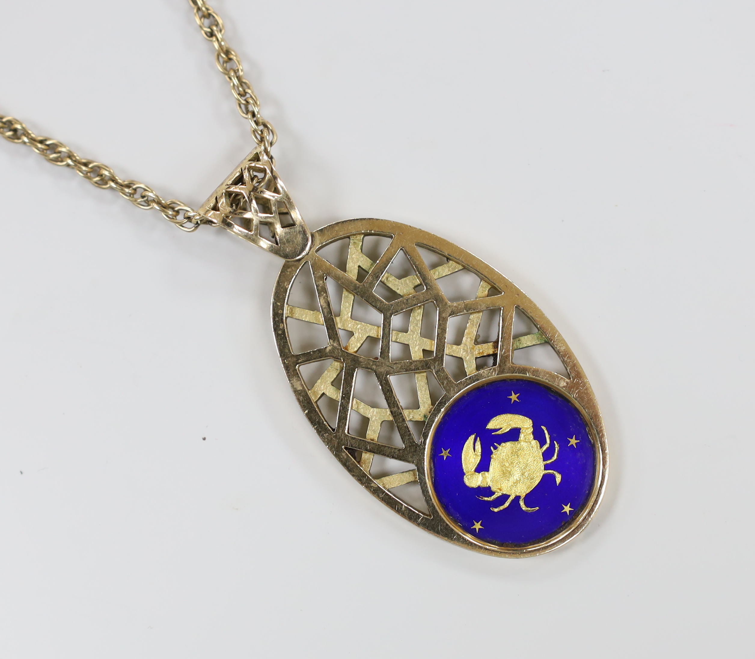 A 1970's pierced 9ct yellow gold and enamel sign of the zodiac oval pendant depicting Cancer, 74mm, gross weight 33.3 grams, on an associated yellow metal chain, 64cm, 18 grams.